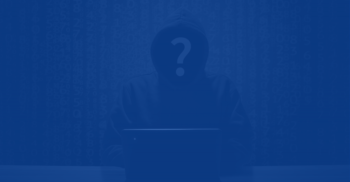 Anonymous hooded human sitting at a computer