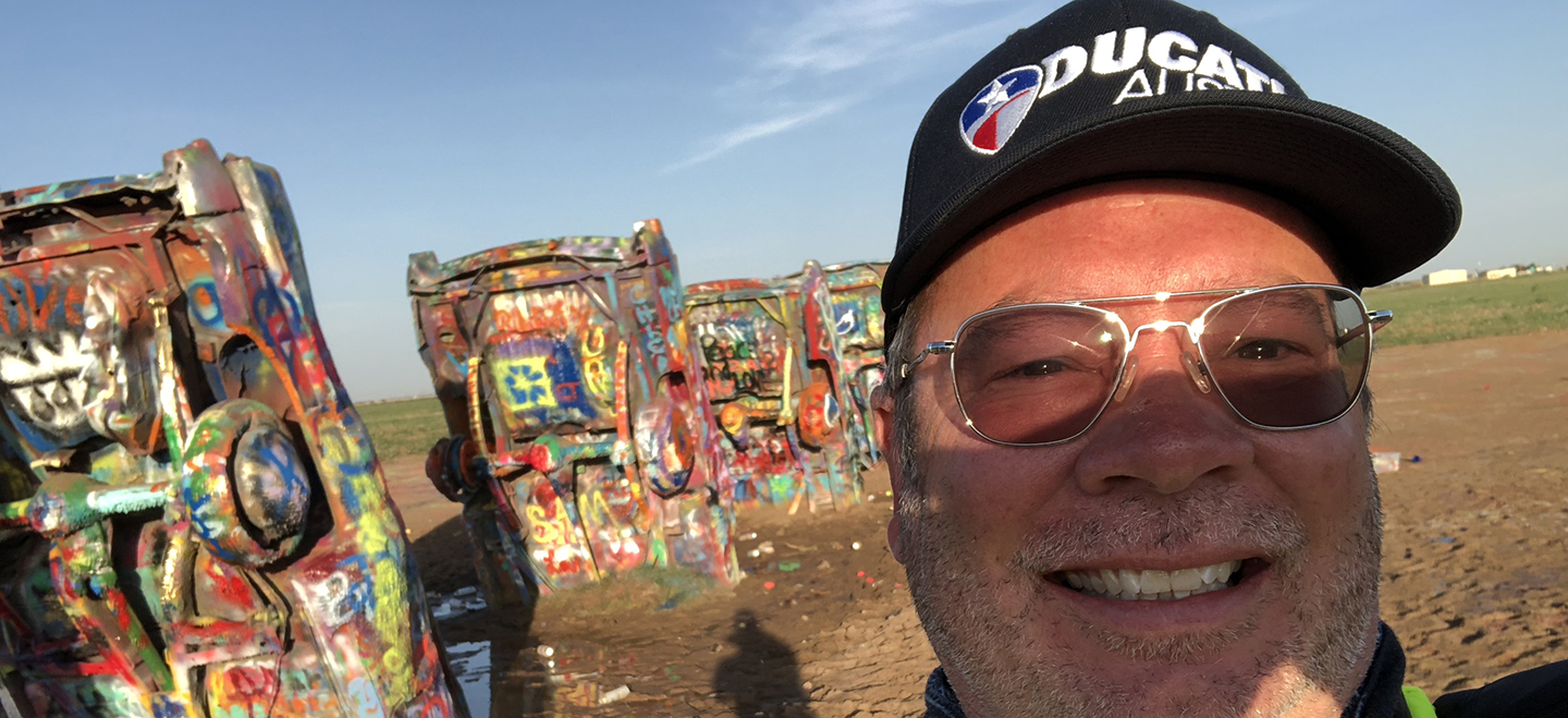 Spray painted cars stuck in the ground at Cadillac Ranch, Texas.