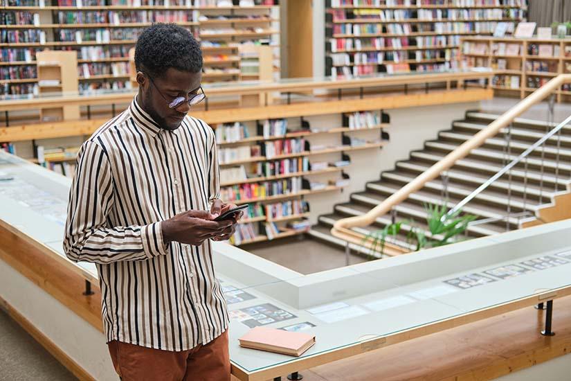 Man on phone in library