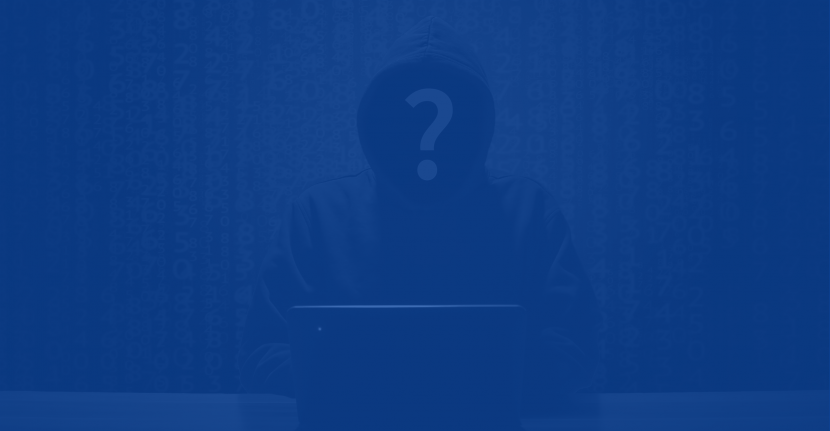 Anonymous hooded human sitting at a computer